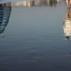 Timelapse footage of a man walking on the beach with Burj Al Arab building in the background