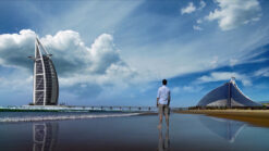 Timelapse footage of a man walking on the beach with Burj Al Arab building in the background